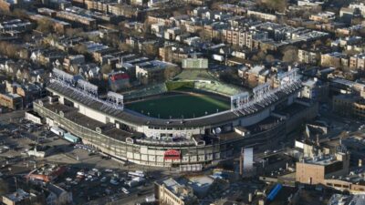 An overhead view of Wrigley Field surrounded by dense Chicago neighborhood streets.