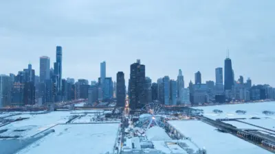 Aerial view of the snow-covered Chicago skyline and Navy Pier in winter.