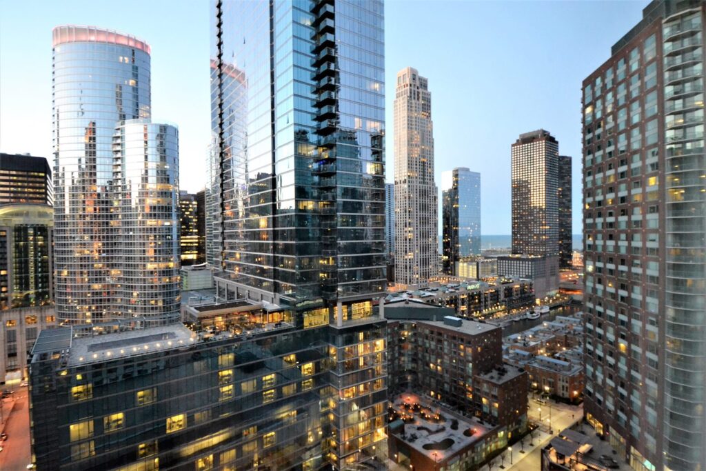 Downtown Chicago condo high-rises at dusk with lit windows