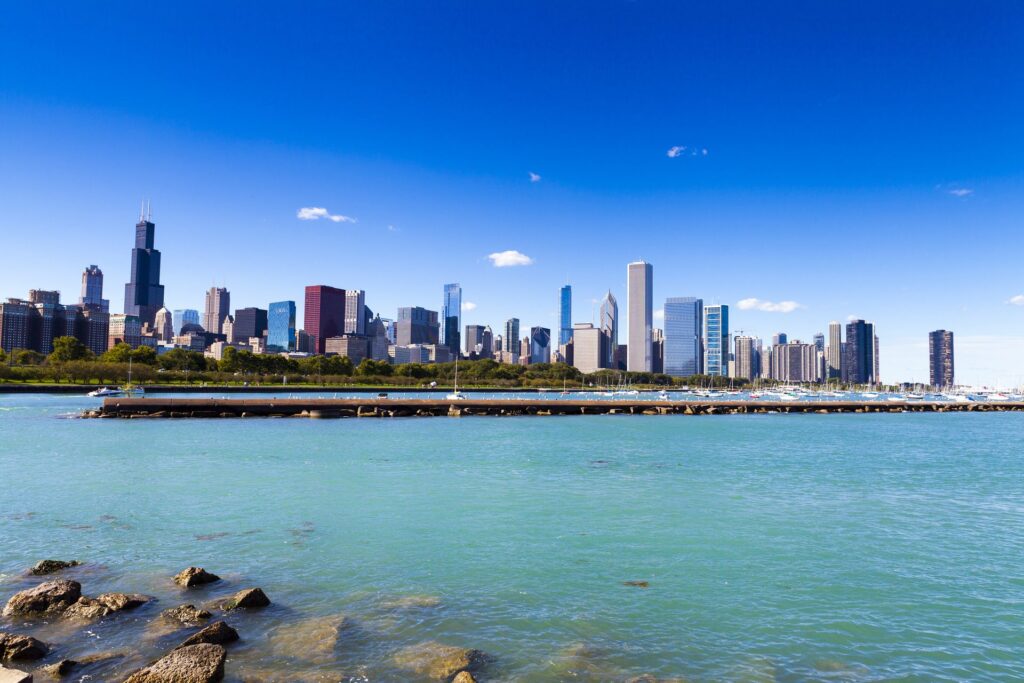 Chicago's downtown skyline and Lake Michigan shoreline on a clear summer day.