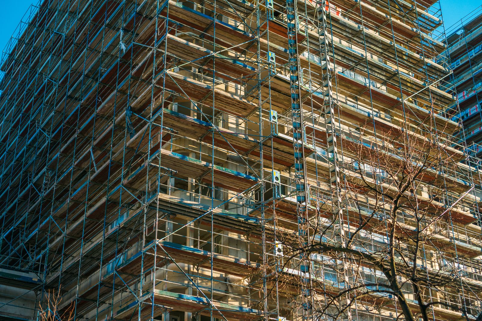 High-rise building wrapped in scaffolding for exterior work