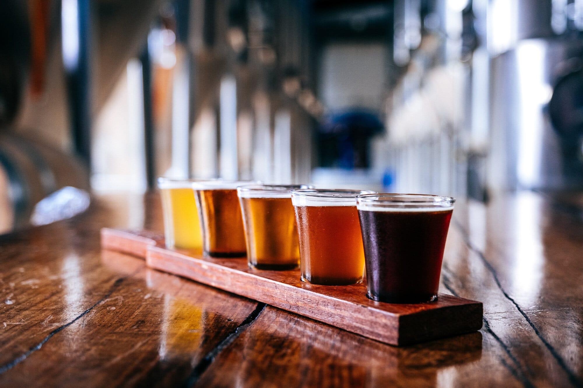 Flight of craft beers on a wooden bar at a Chicago brewery